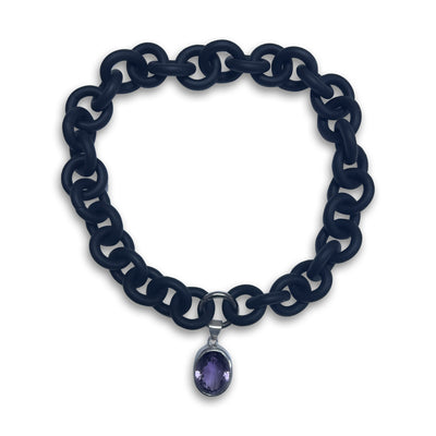 BLACK RUBBER NECKLACE WITH PENDENT BEZEL SET IN SILVER WITH A LARGE PURPLE AMETHYST STONE.