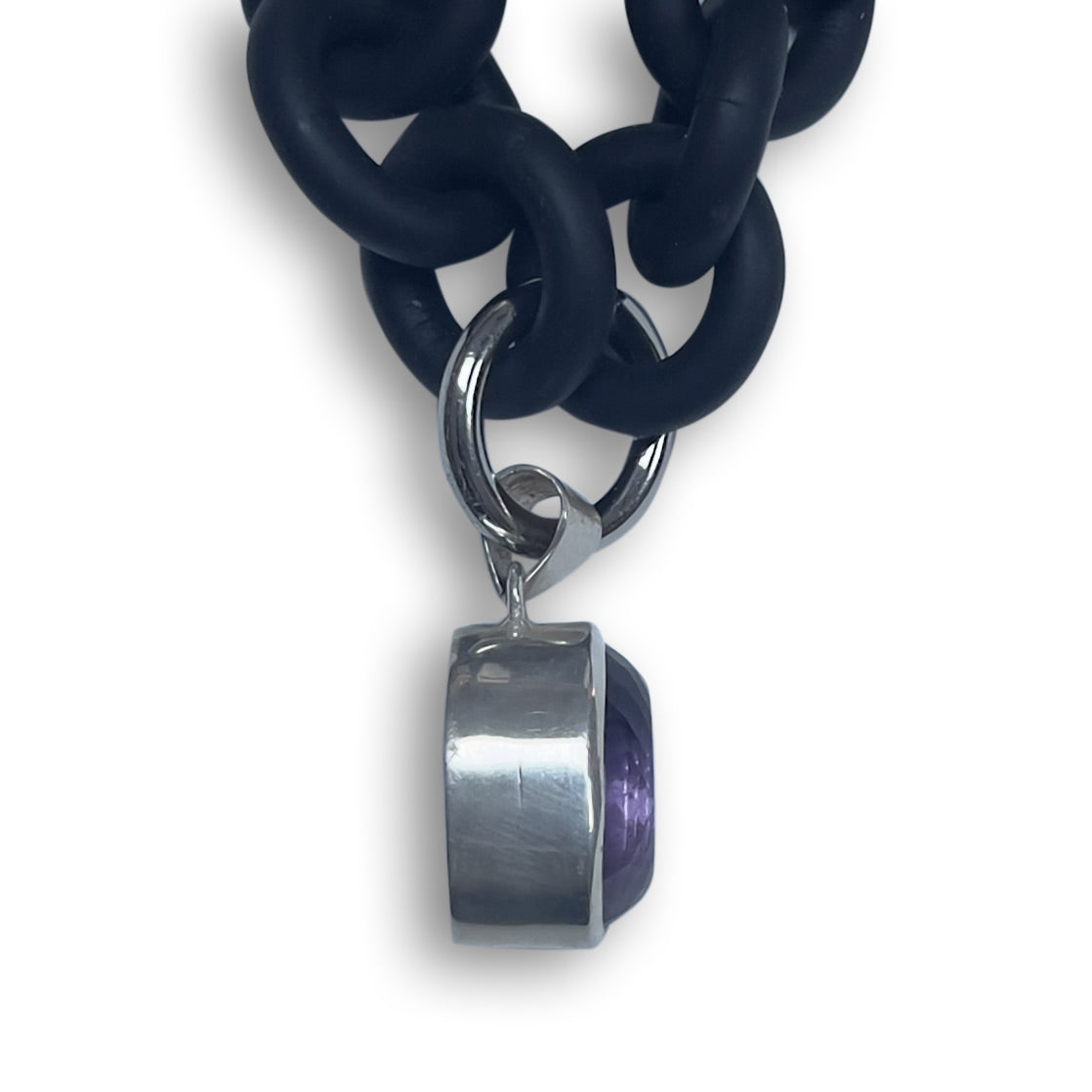 BLACK RUBBER NECKLACE WITH PENDENT BEZEL SET IN SILVER WITH A LARGE PURPLE AMETHYST STONE.