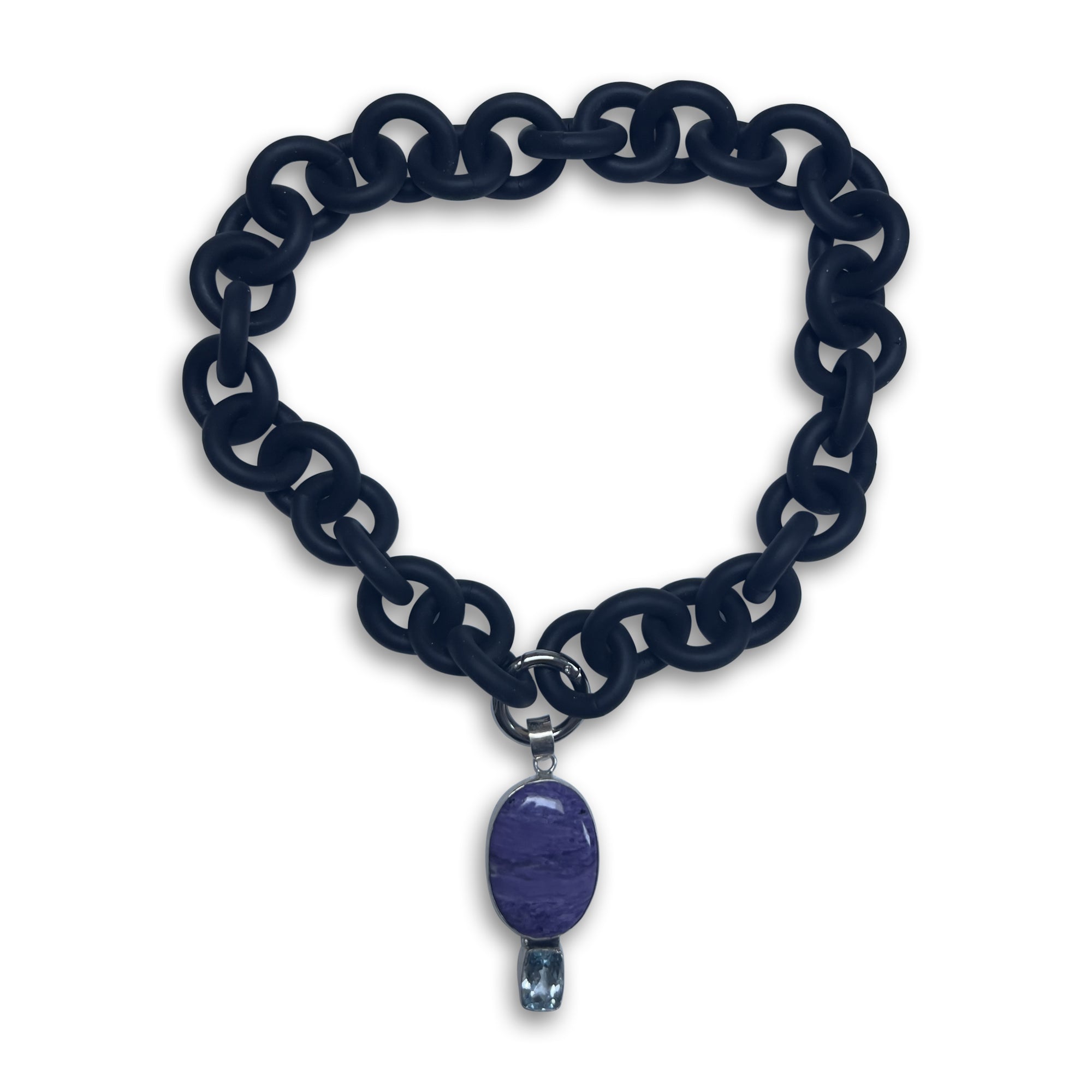 BLACK RUBBER NECKLACE WITH PENDENT BEZEL SET IN SILVER WITH A LARGE CHAROITE STONE AND A LIGHT BLUE TOPAZ STONE.