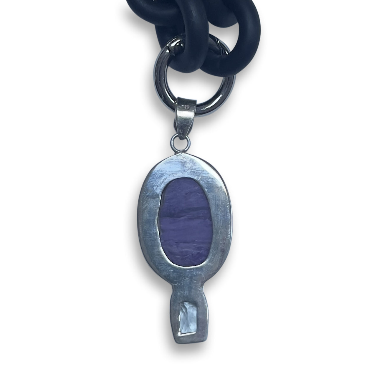 BLACK RUBBER NECKLACE WITH PENDENT BEZEL SET IN SILVER WITH A LARGE CHAROITE STONE AND A LIGHT BLUE TOPAZ STONE.