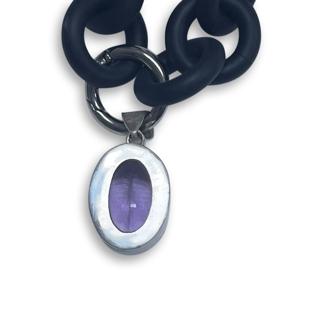 BLACK RUBBER NECKLACE WITH PENDENT BEZEL SET IN SILVER WITH A LARGE PURPLE AMETHYST STONE.