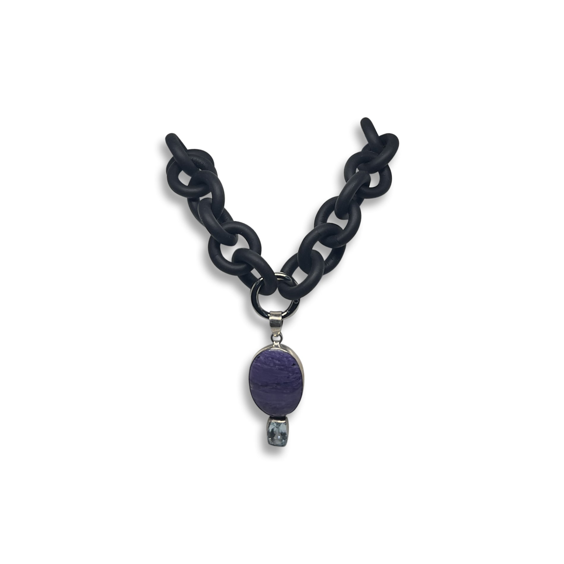 BLACK RUBBER NECKLACE WITH PENDENT BEZEL SET IN SILVER WITH A LARGE CHAROITE STONE AND A LIGHT BLUE TOPAZ STONE.