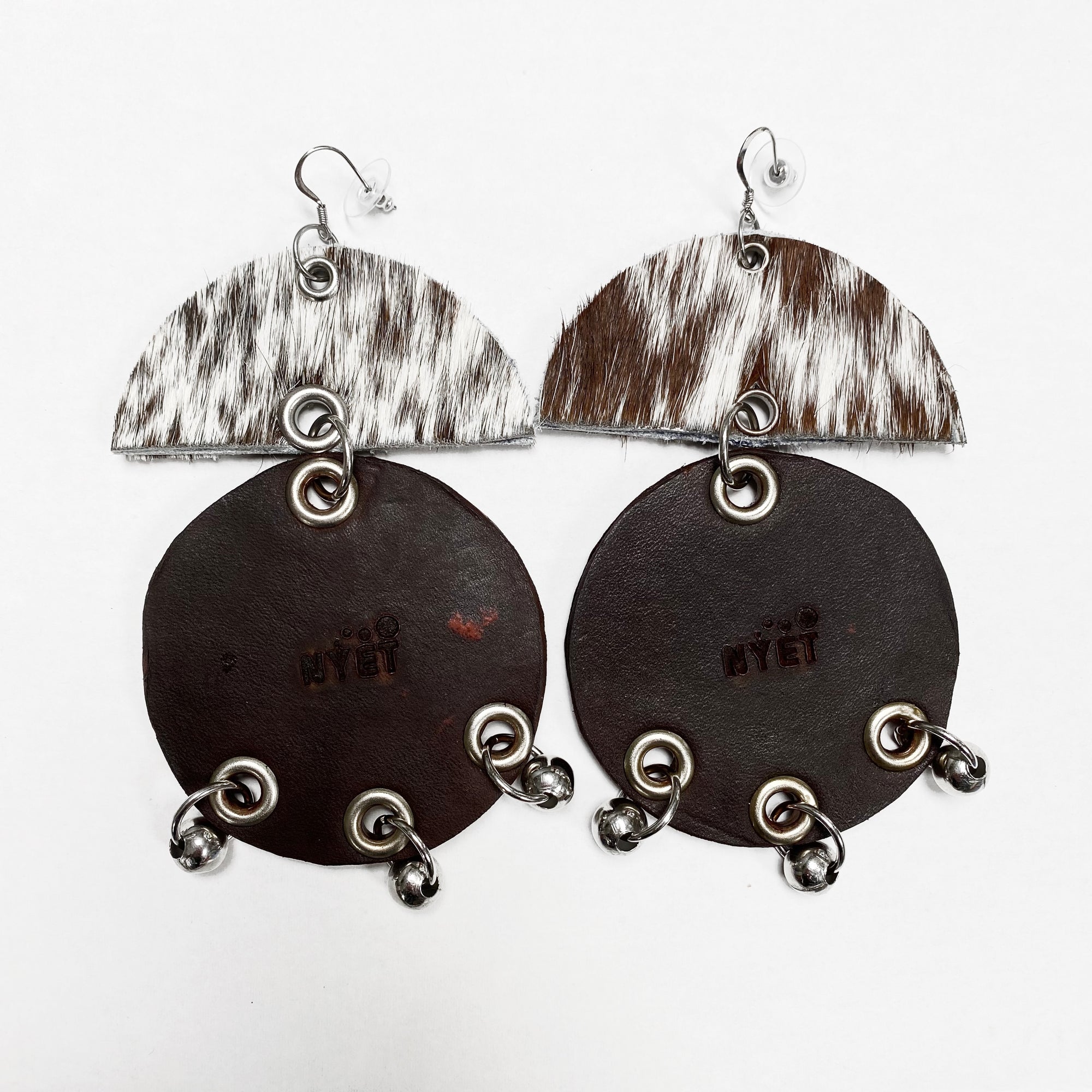 WIDE HAIR-ON AND TANNED COWHIDE EARRINGS WITH SEMI CIRCLE AND LARGE CIRCLE PENDANTS ADORNED WITH STAINLESS STEEL BEADS. by NYET Jewelry