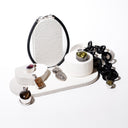 Set of jewelry on a white stand with a white background