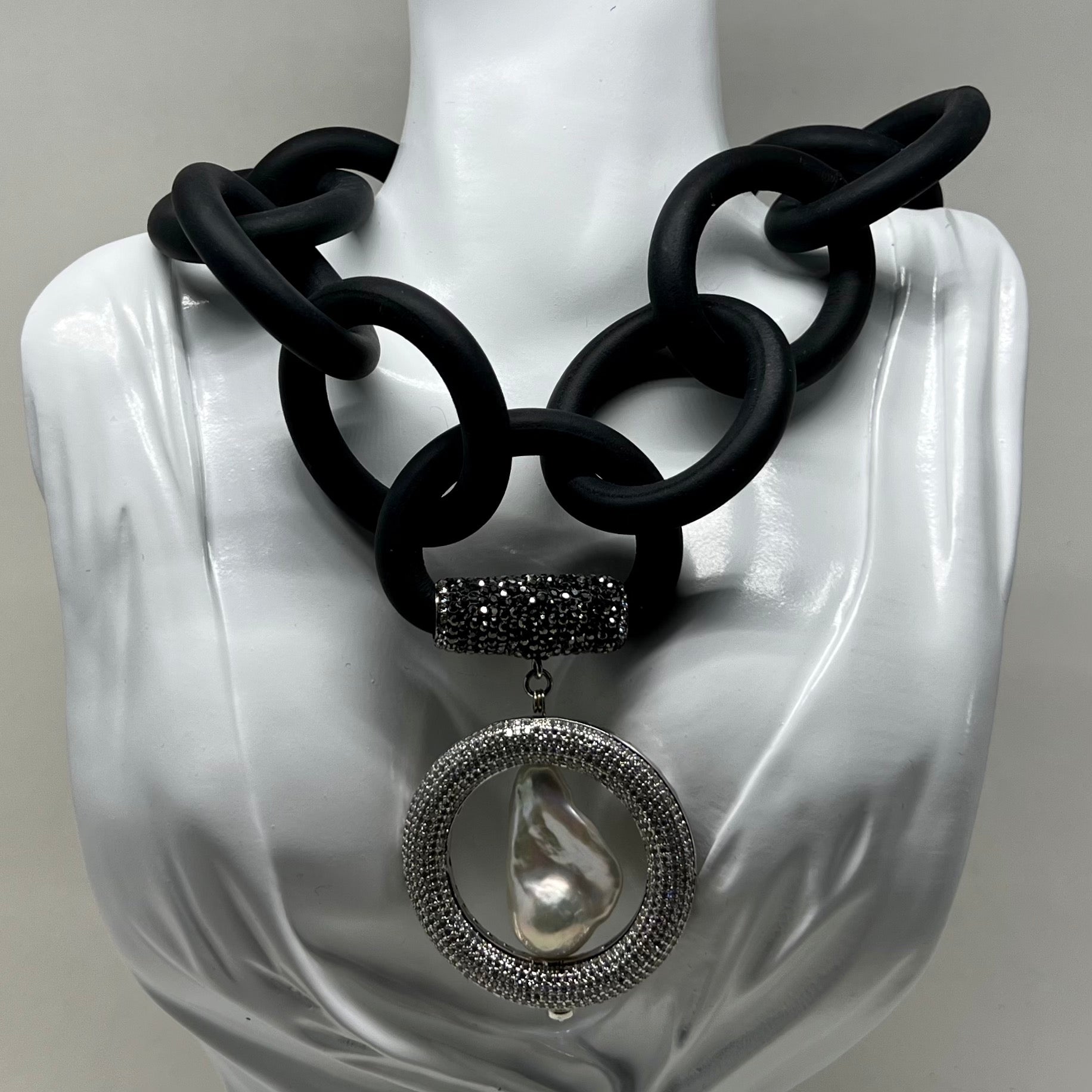 BLACK RUBBER NECKLACE WITH GENUINE LARGE BAROQUE PEARL SET INSIDE A PAVE'S CZ CIRCLE PENDENT. by nyet jewelry