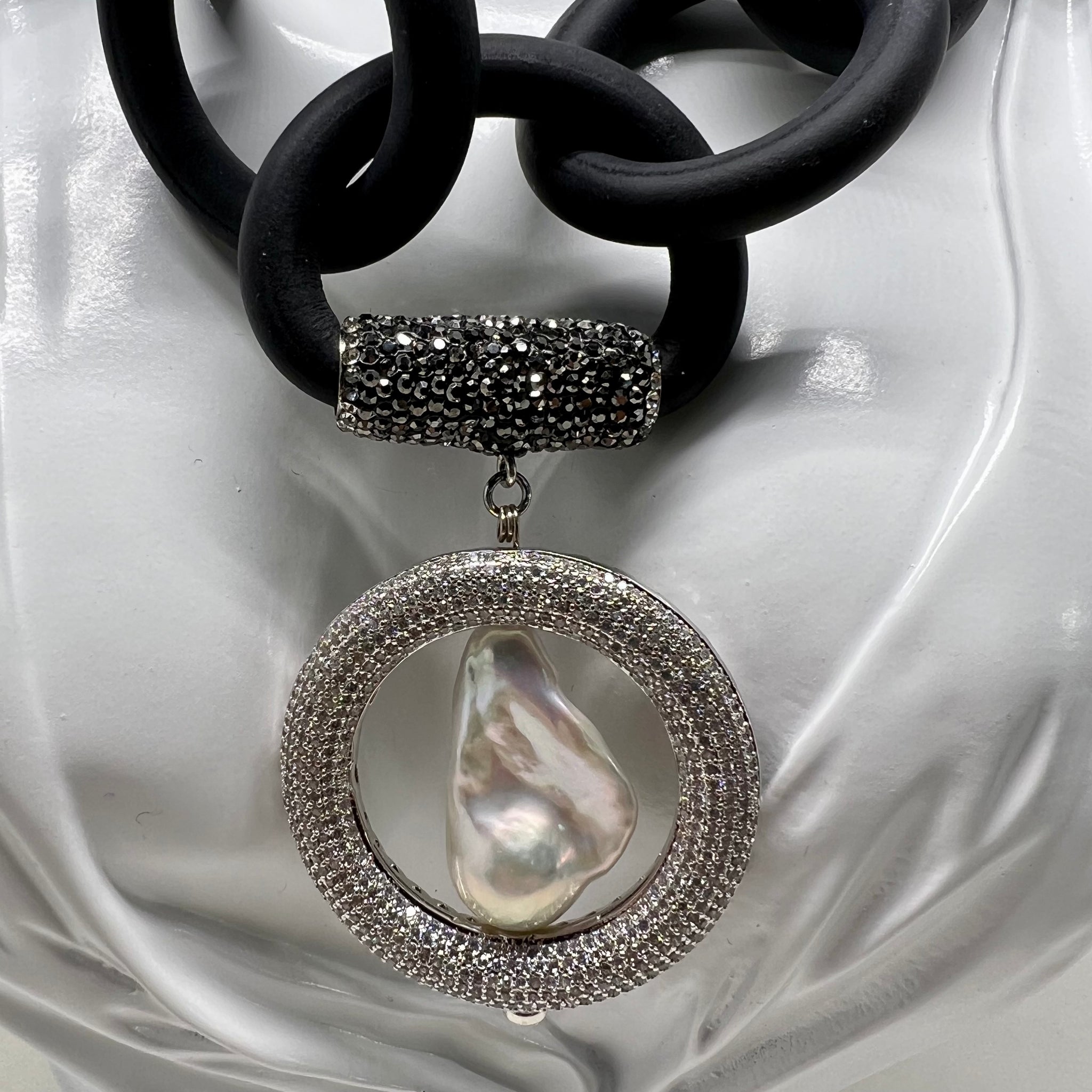 BLACK RUBBER NECKLACE WITH GENUINE LARGE BAROQUE PEARL SET INSIDE A PAVE'S CZ CIRCLE PENDENT. by nyet jewelry