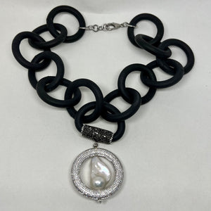 BLACK RUBBER NECKLACE WITH GENUINE LARGE BAROQUE PEARL SET INSIDE A PAVE'S CZ CIRCLE PENDENT. by nyet jewelry