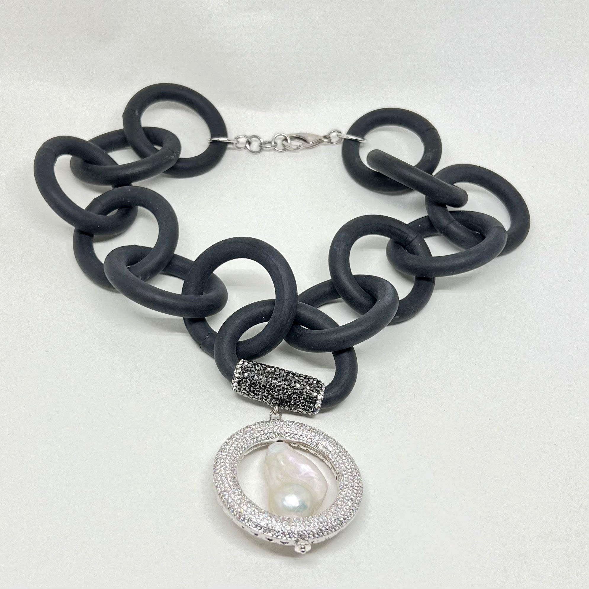 BLACK RUBBER NECKLACE WITH GENUINE LARGE BAROQUE PEARL SET INSIDE A PAVE'S CZ CIRCLE PENDENT. by nyet jewelry