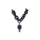  BLACK RUBBER NECKLACE WITH PENDENT BEZEL SET IN SILVER WITH A LARGE CHAROITE STONE AND A LIGHT BLUE TOPAZ STONE.
