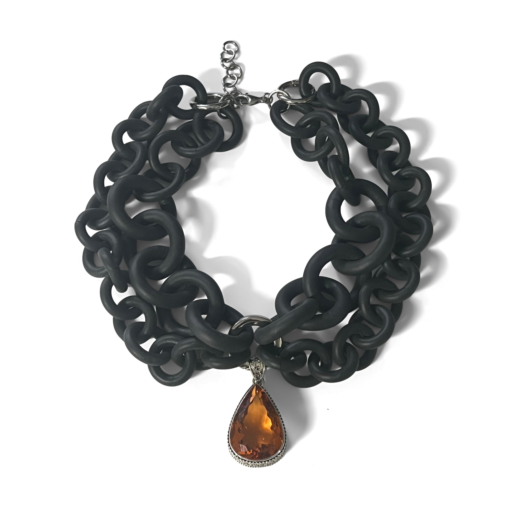 2-STRAND BLACK RUBBER NECKLACE WITH AN ORANGE QUARTZ STONE WRAPPED IN FILIGREE SILVER. by NYET Jewelry.