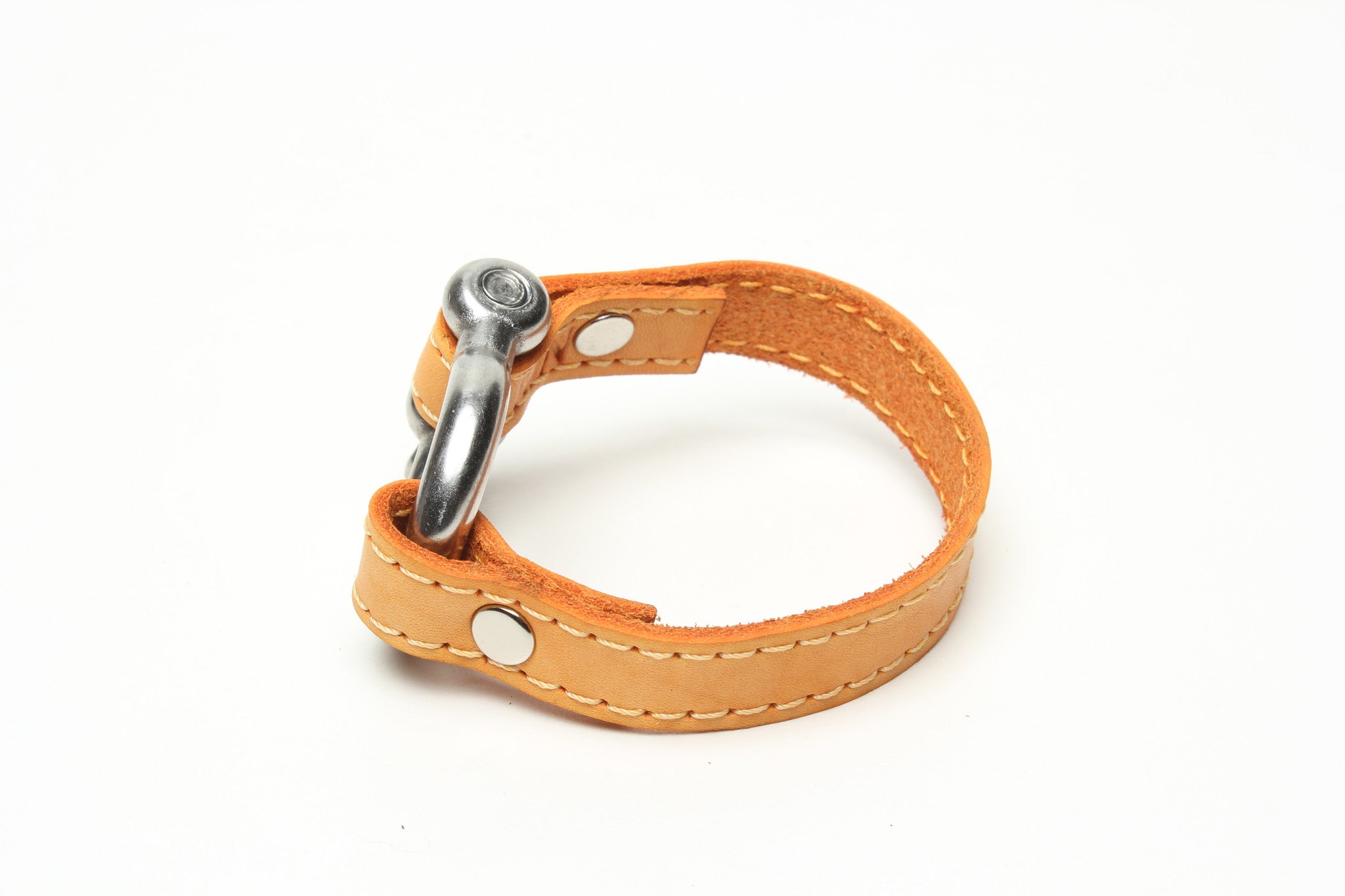 SIGNATURE STITCHED LEATHER AND STAINLESS STEEL SHACKLE BY NYET JEWELRY.