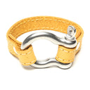 SIGNATURE STITCHED LEATHER AND STAINLESS STEEL SHACKLE BY NYET JEWELRY.