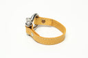 SIGNATURE STITCHED LEATHER AND STAINLESS STEEL SHACKLE BY NYET JEWELRY.