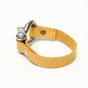 SIGNATURE STITCHED LEATHER AND STAINLESS STEEL SHACKLE BY NYET JEWELRY.