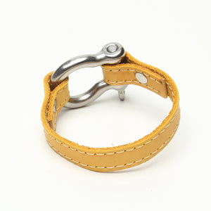 SIGNATURE STITCHED LEATHER AND STAINLESS STEEL SHACKLE BY NYET JEWELRY.