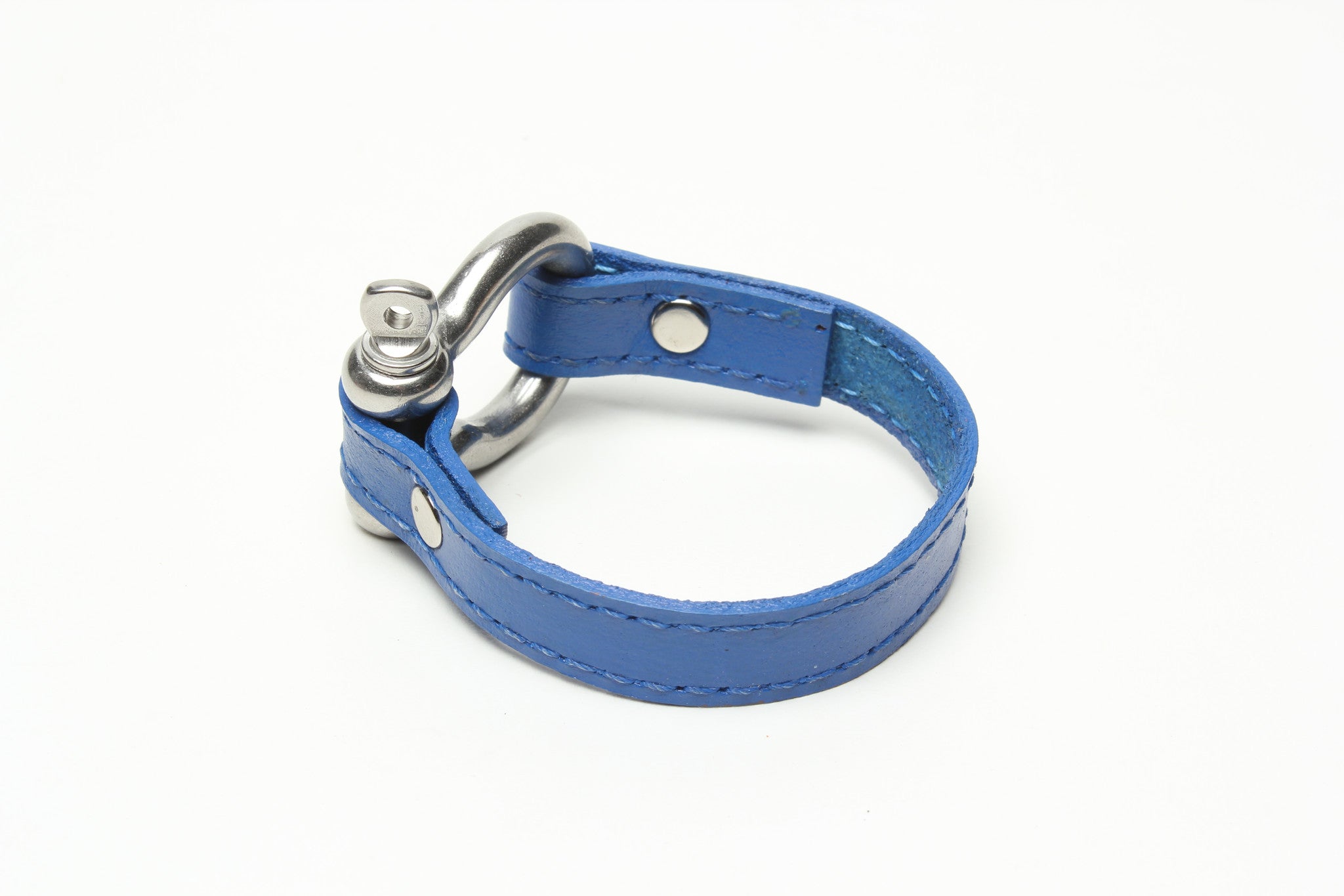 SIGNATURE STITCHED LEATHER AND STAINLESS STEEL SHACKLE BY NYET JEWELRY.