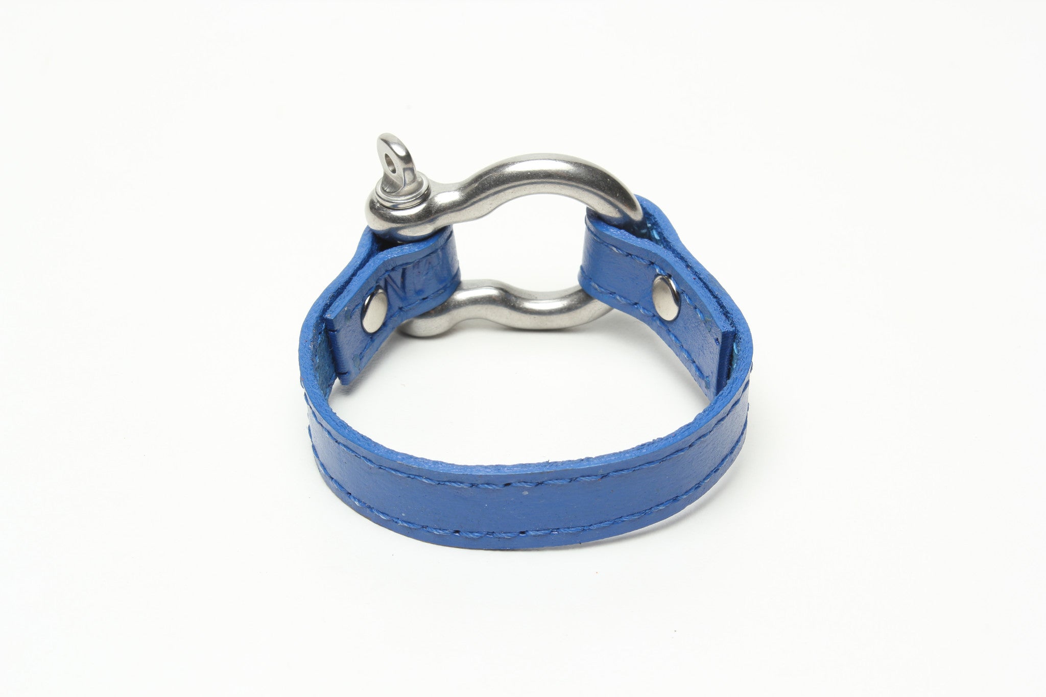 SIGNATURE STITCHED LEATHER AND STAINLESS STEEL SHACKLE BY NYET JEWELRY.