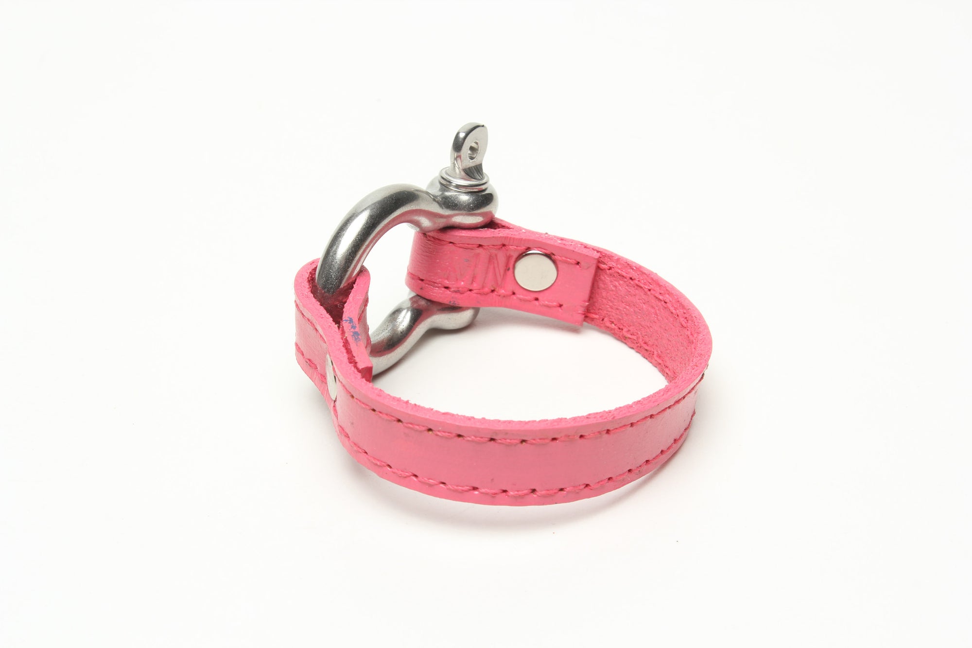 SIGNATURE STITCHED LEATHER AND STAINLESS STEEL SHACKLE BY NYET JEWELRY.