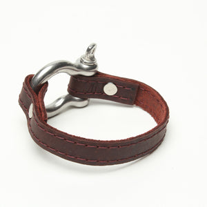 SIGNATURE STITCHED LEATHER AND STAINLESS STEEL SHACKLE BY NYET JEWELRY.