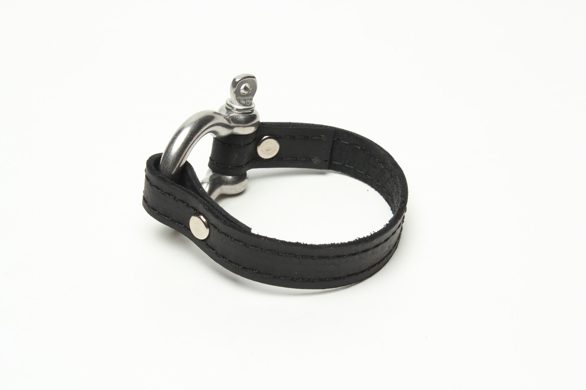 SIGNATURE STITCHED LEATHER AND STAINLESS STEEL SHACKLE BY NYET JEWELRY.