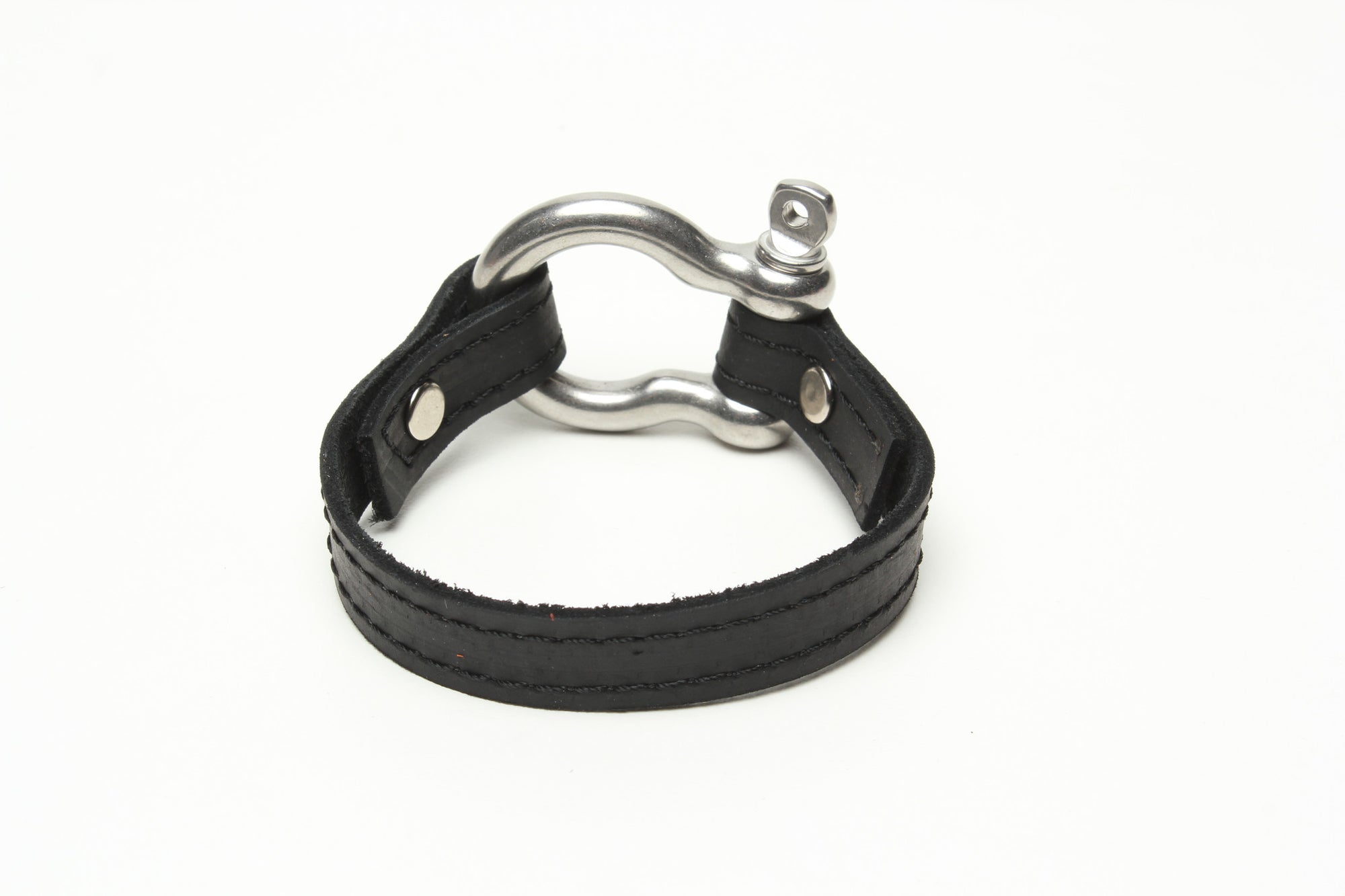 SIGNATURE STITCHED LEATHER AND STAINLESS STEEL SHACKLE BY NYET JEWELRY.