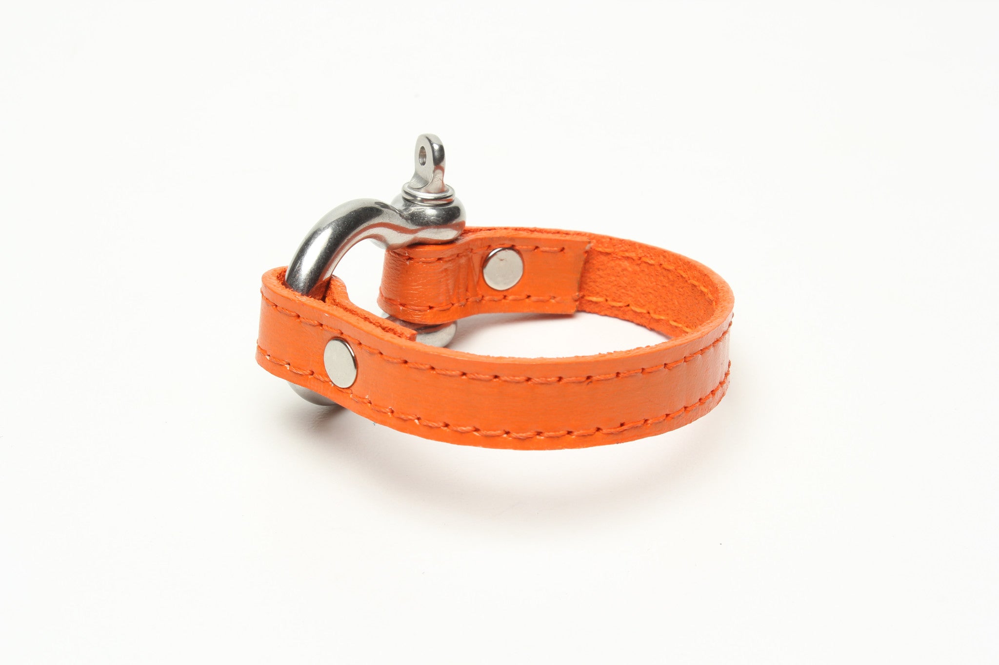 SIGNATURE STITCHED LEATHER AND STAINLESS STEEL SHACKLE BY NYET JEWELRY.