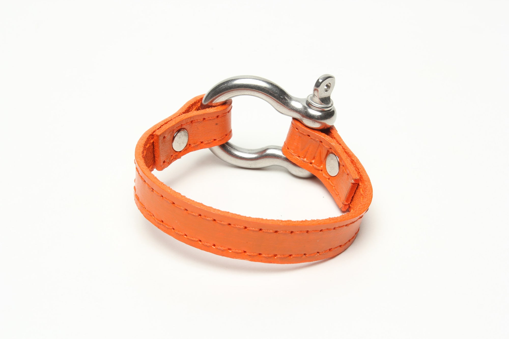 SIGNATURE STITCHED LEATHER AND STAINLESS STEEL SHACKLE BY NYET JEWELRY.