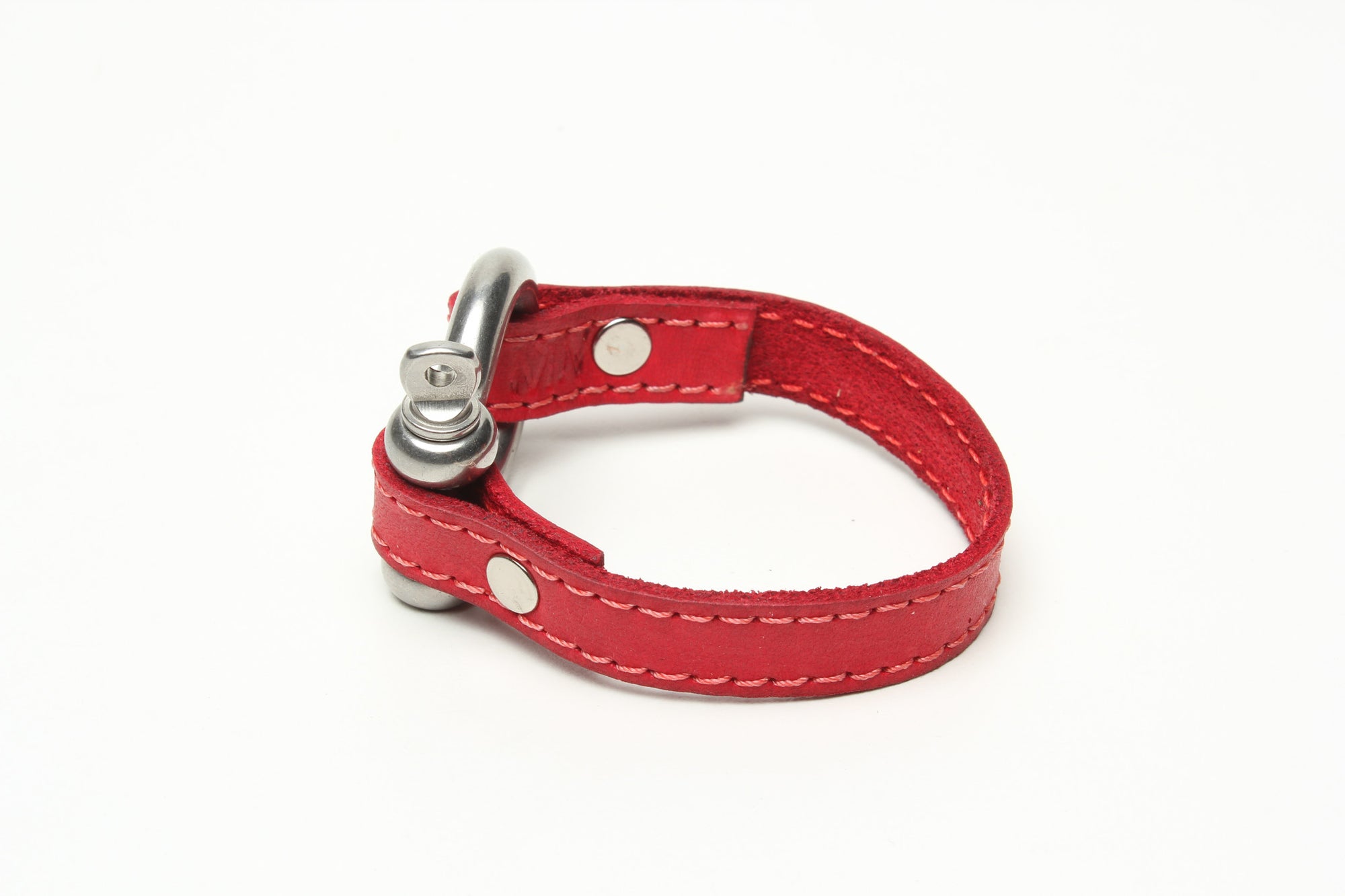 SIGNATURE STITCHED LEATHER AND STAINLESS STEEL SHACKLE BY NYET JEWELRY.