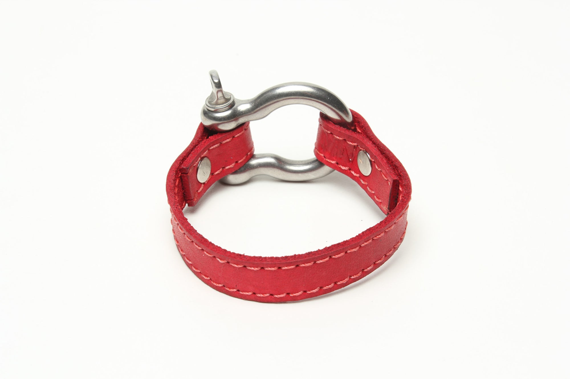 SIGNATURE STITCHED LEATHER AND STAINLESS STEEL SHACKLE BY NYET JEWELRY.