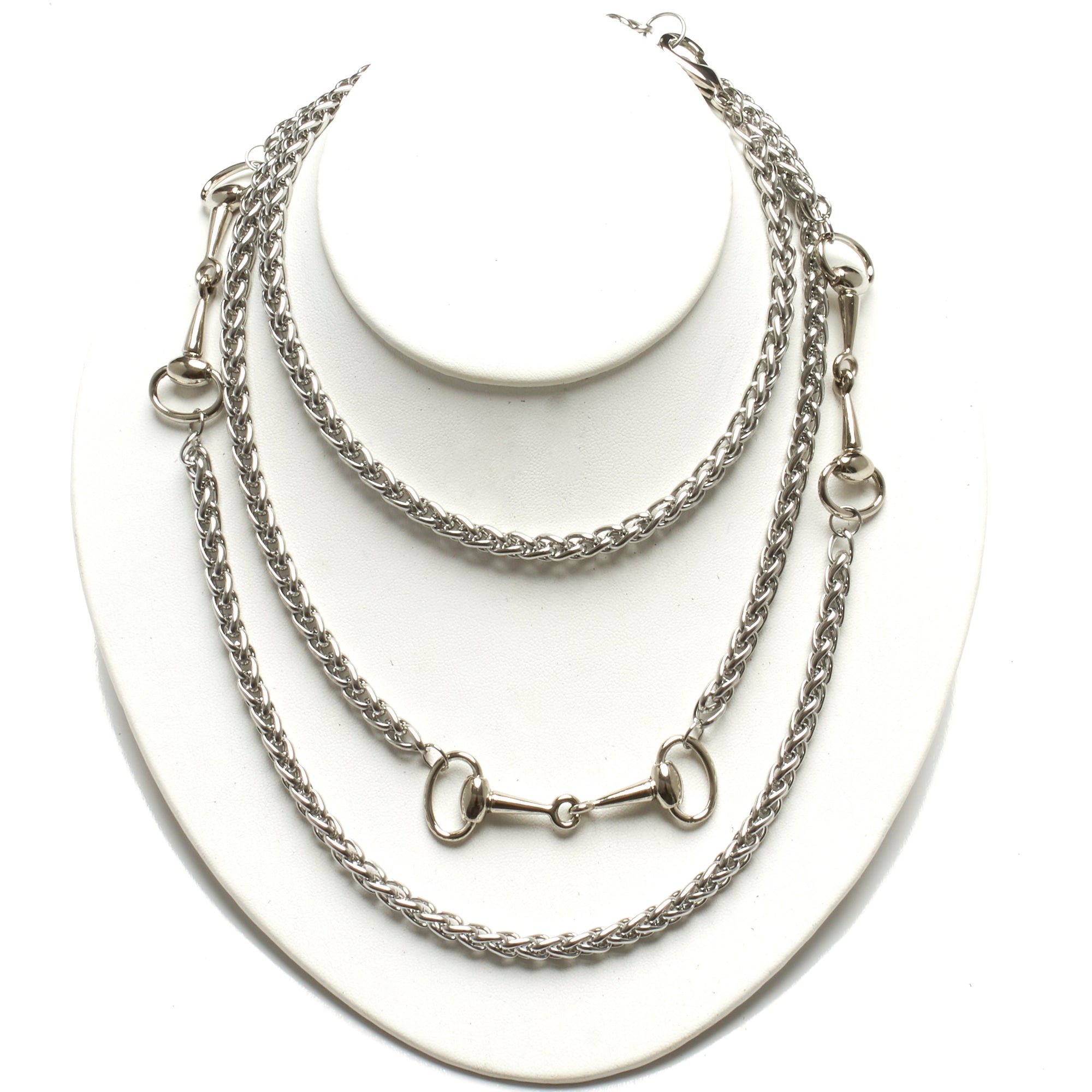 LONG STAINLESS STEEL NECKLACE ADORNED WITH THREE HORSE-BIT ACCENT HARDWARE. by nyet jewelry.