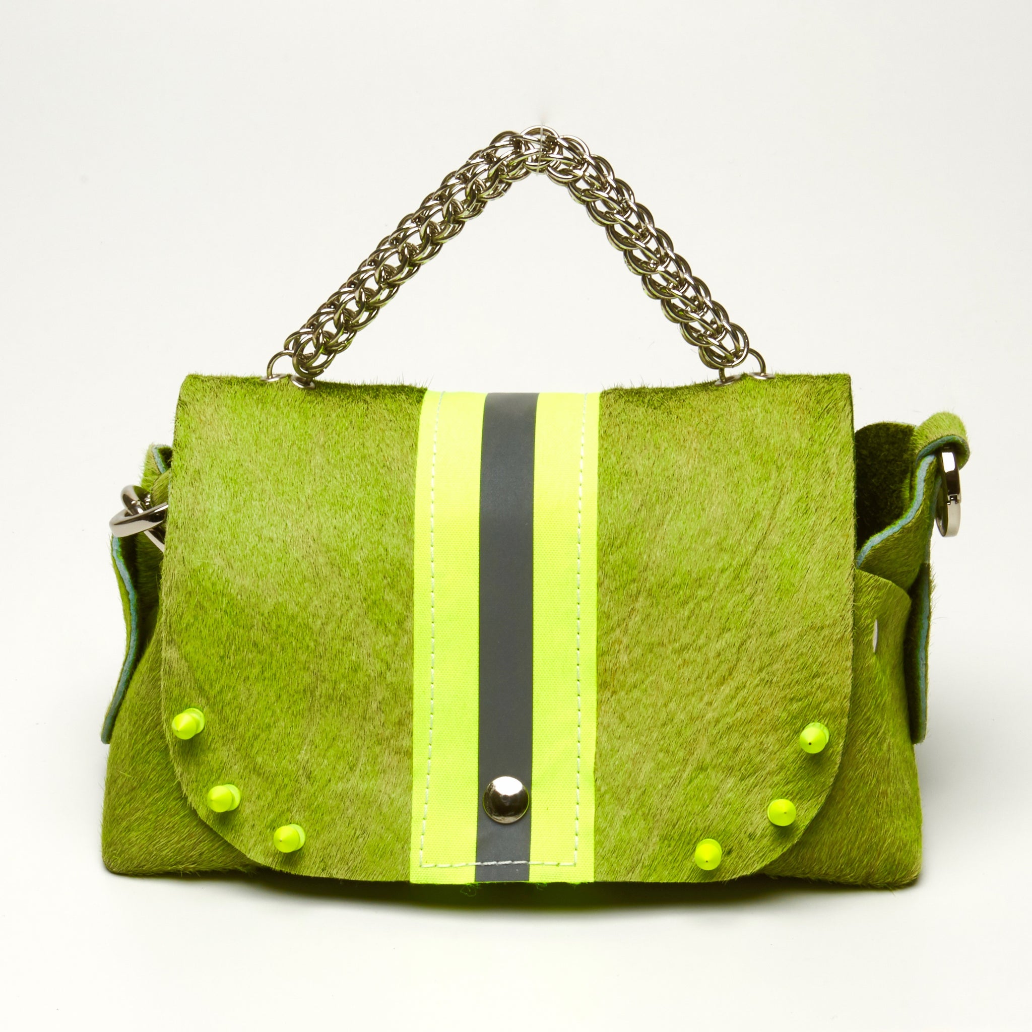 HAIR-ON COWHIDE LEATHER WITH WIDE NEON YELLOW REFLECTIVE TRIM RIVETED DAY-TO-EVENING BAG WITH STAINLESS STEEL METAL HARDWARE, CHAIN MAILLE HANDLE AND REMOVABLE SHOULDER STRAP.
