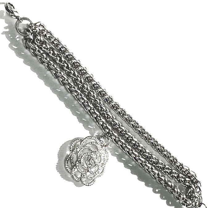 STAINLESS STEEL BRACELET ADORNED WITH A VZ PAVE CAMELLIA PENDENT. by nyet jewelry