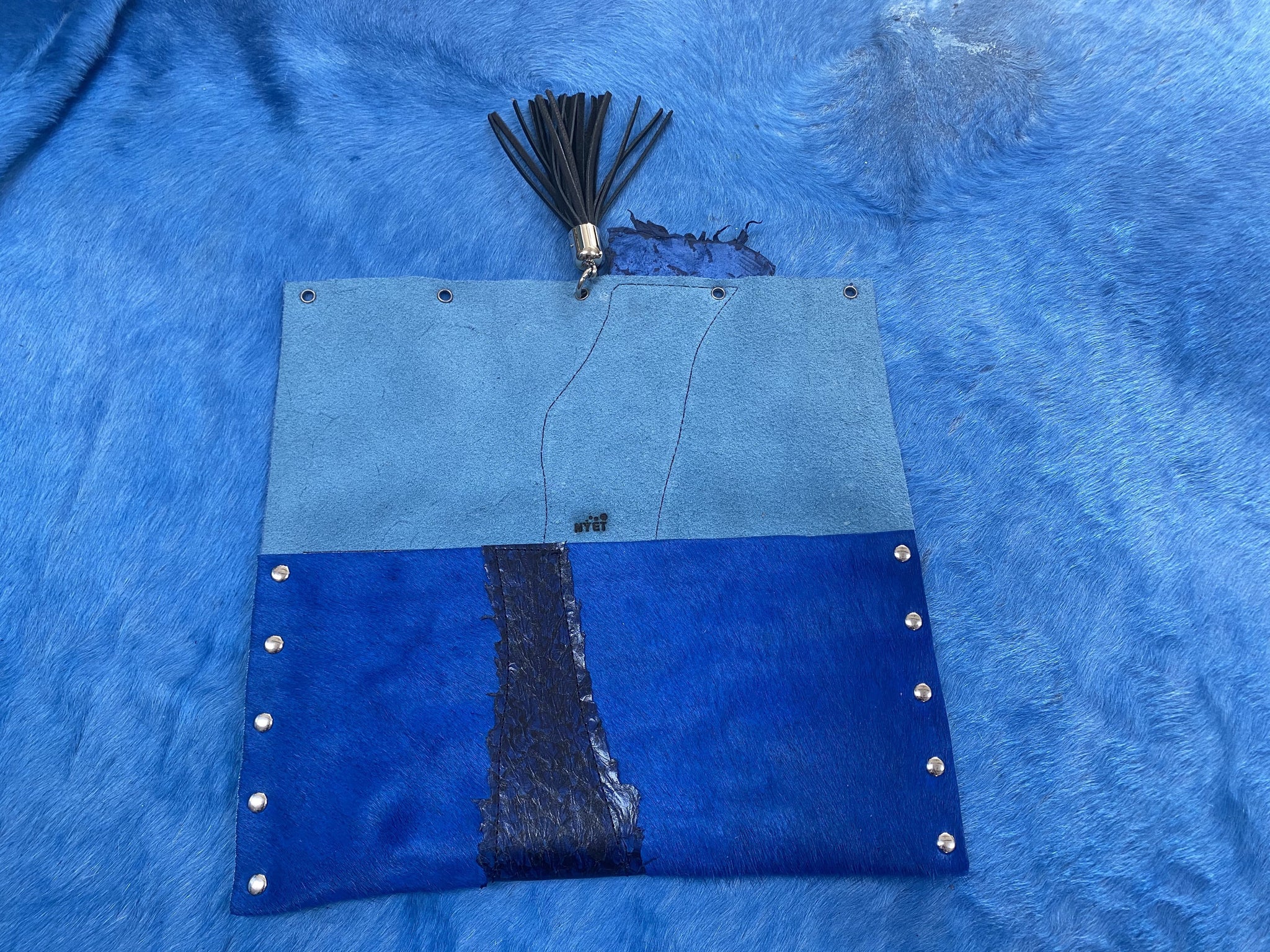 Fish leather and cowhide clutch with deerskin tassel