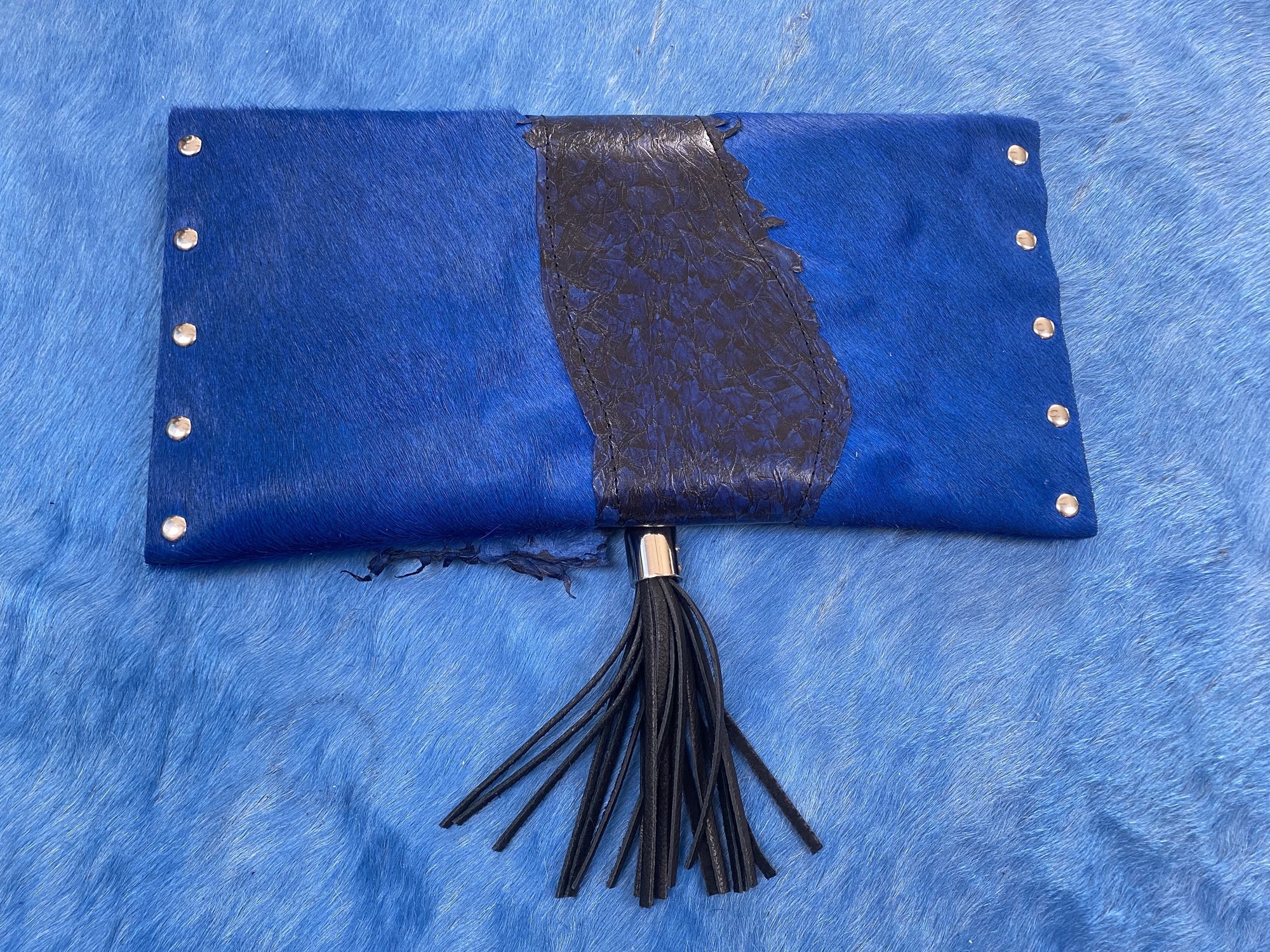 Fish leather and cowhide clutch with deerskin tassel