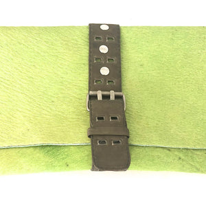 GREEN HAIR-ON COWHIDE CLUTCH WITH DETAILED UTILITY LEATHER STRAP AND BELT BUCKLE-STYLE CLOSURE by nyet jewelry