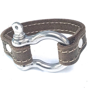 SIGNATURE STITCHED LEATHER AND STAINLESS STEEL SHACKLE BY NYET JEWELRY.