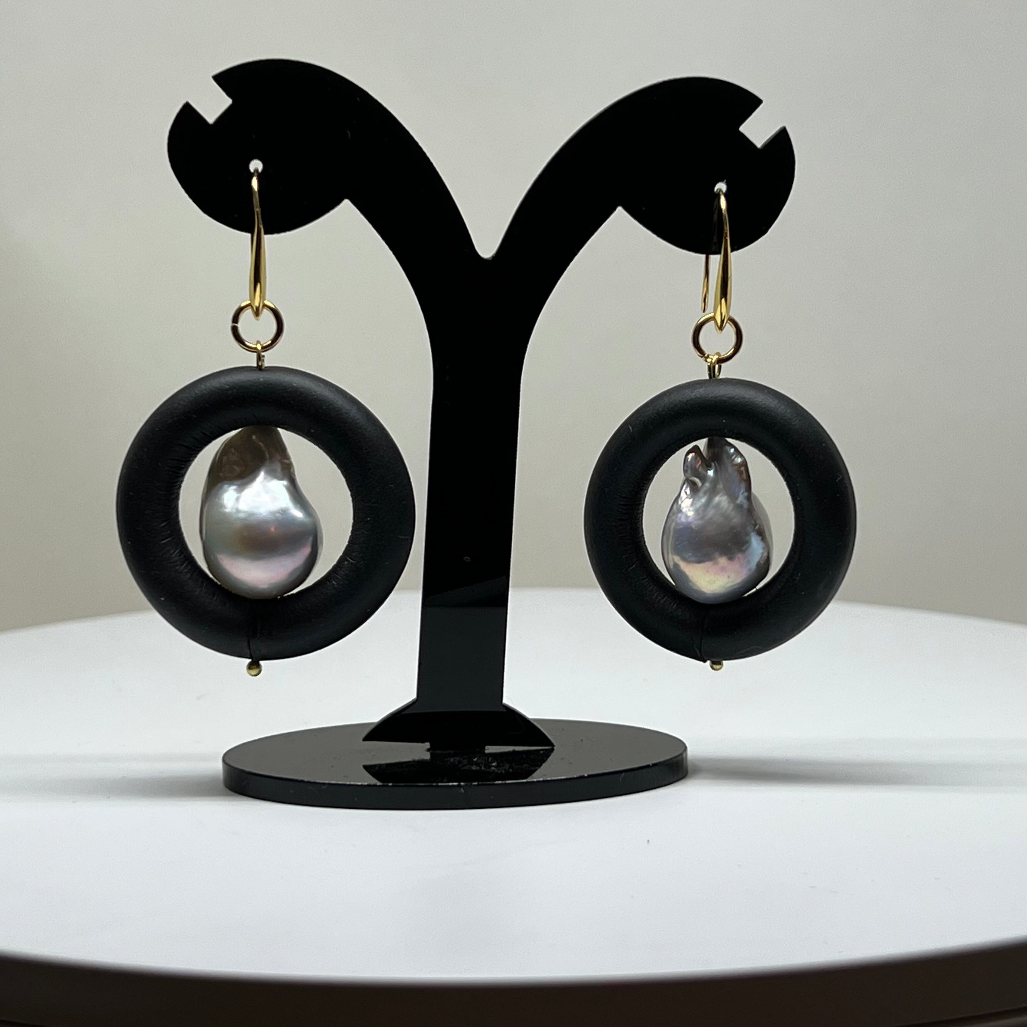 BLACK RUBBER EARRINGS WITH GENUINE BAROQUE PEARLS AND GOLD ENDCAPS. by nyet jewelry