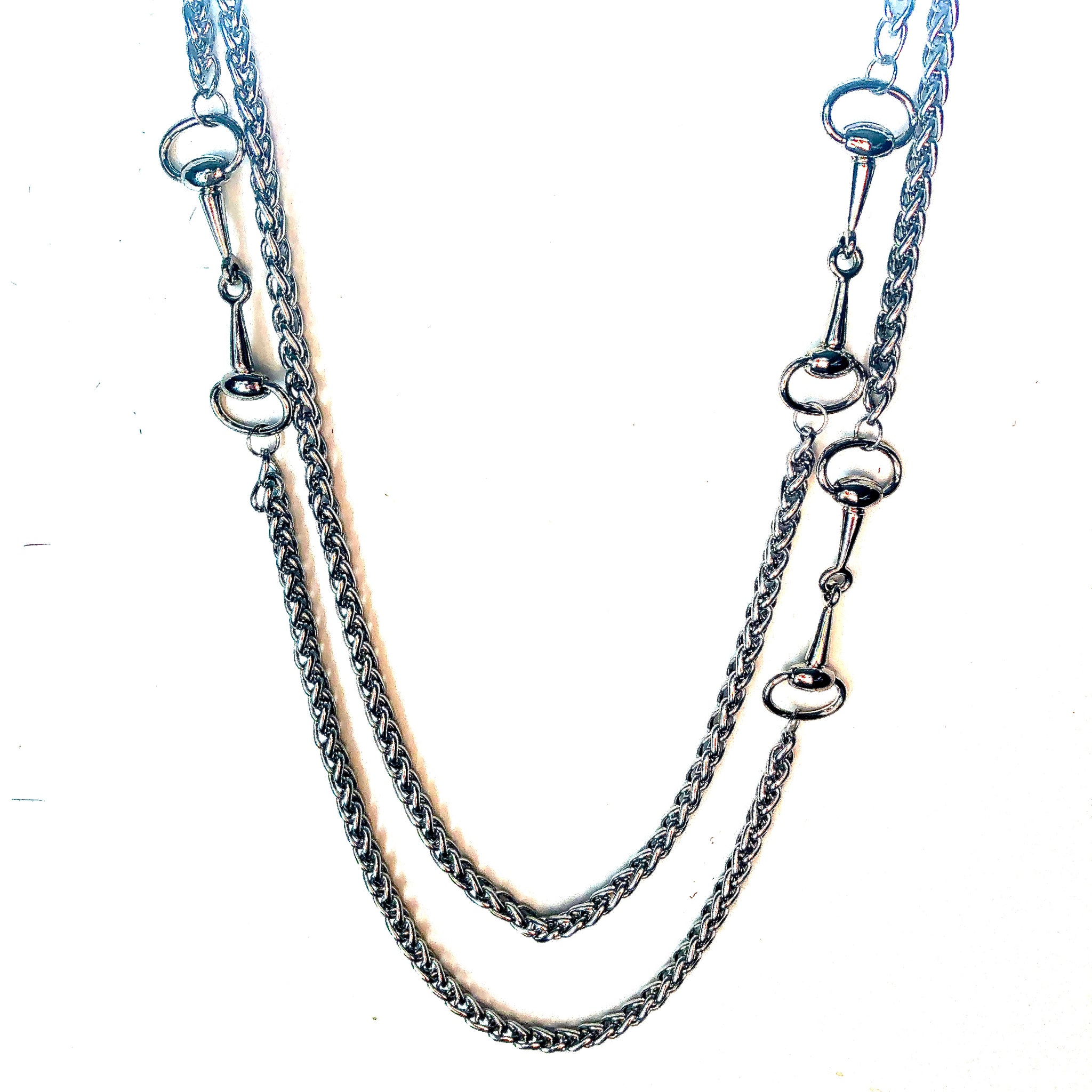 LONG STAINLESS STEEL NECKLACE ADORNED WITH THREE HORSE-BIT ACCENT HARDWARE. by nyet jewelry.