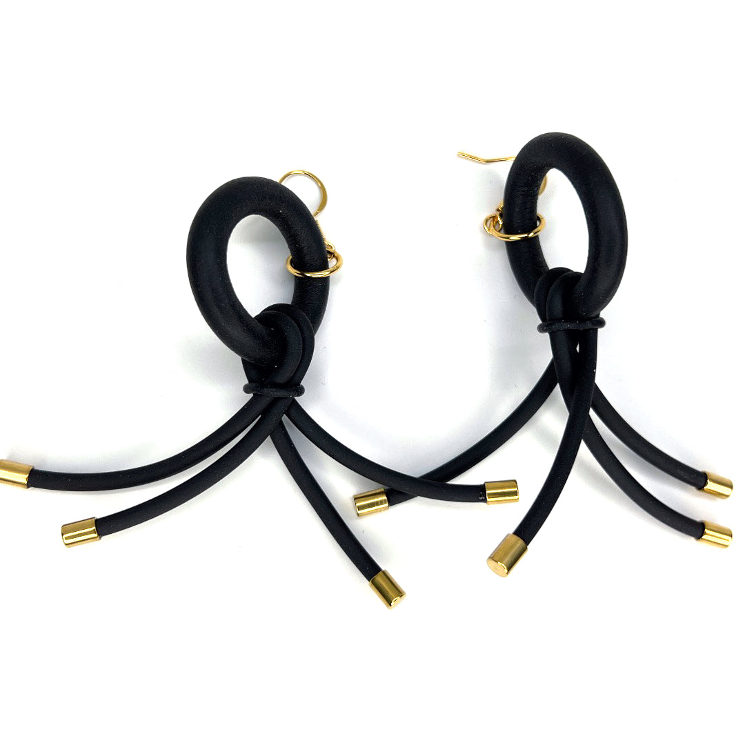 BLACK RUBBER EARRINGS WITH GOLD ENDCAP ACCENTS. by nyet jewelry
